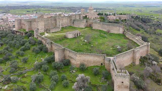Aerial view of Trujillo Castle ruins in Caceres, Spain. Historic hilltop fortress remains open to visitors, medieval stone structures overlooking Castilla La Mancha landscape.