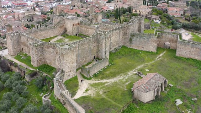 Aerial view of Trujillo Castle ruins in Caceres, Spain. Historic hilltop fortress remains open to visitors, medieval stone structures overlooking Castilla La Mancha landscape.