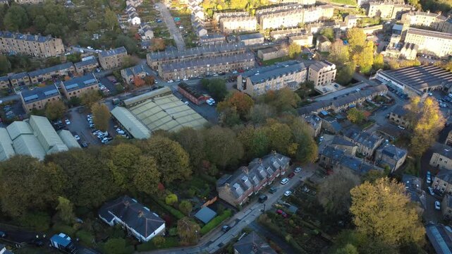 aerial view of the town of Hebden Bridge in autumn sunlight showing streets of houses