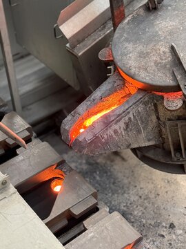 Melted metal pouring in to the sand mold in die casting process