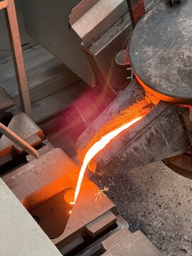 Melted metal pouring in to the sand mold in die casting process