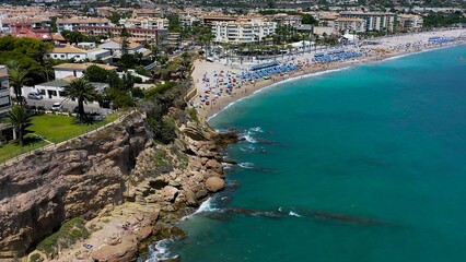 Fototapeta premium Aerial view of the spectacular sand beach of El Albir, with turquoise waters in the Mediterranean Spanish province of Alicante.