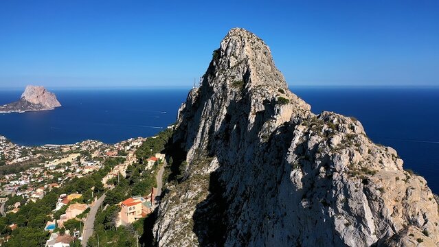 Aerial view of Morro de Toix mountain between Calpe Bay and Altea, a fantastic hiking area joint to the Mediterranean Sea, Spain. Drone view of the viewpoint over Calpe Bay, in Spain.