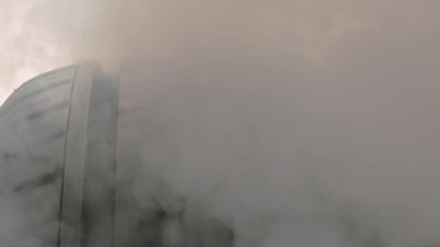 Tread Friction Creates Smoke Flow. The spinning wheel rubs against the asphalt and creates a cloud of white smoke on a white background