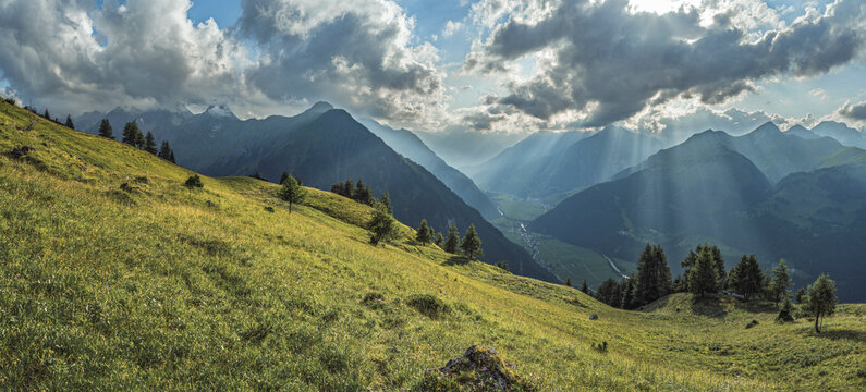 Spectacular wide panorama of the Lechtal valley with sun rays breaking through clouds. View from Elbigenalp towards Warth and J&ouml;chlspitze. Summer mountain landscape in the Tyrolean Alps, Austria.