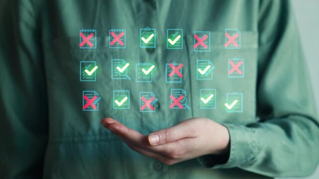 Hand shows digital checklist with items marked as completed or not completed in an office setting during daytime.