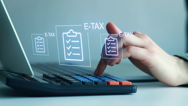 Person using calculator for e-tax preparation with digital checklists on screen in an indoor setting during daytime.