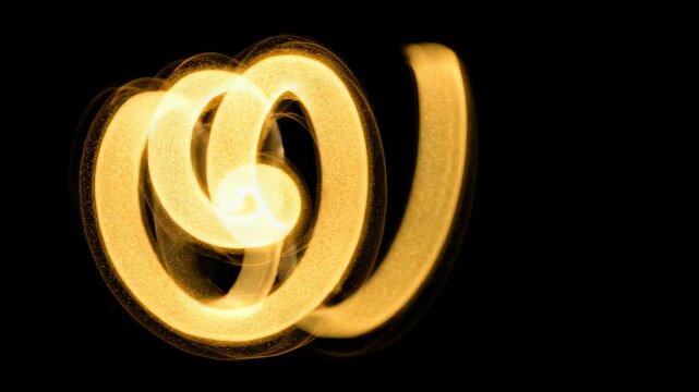 Abstract light trails create dynamic shapes in a dark setting, illustrating a seamless progression of illuminated patterns and curves with golden tones
