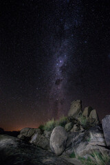 Milky Way rising over boulder field that looks like fantasy © John