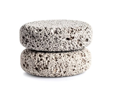 Two textured, porous, light grey, disc-shaped stones are stacked on top of each other