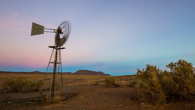Windmill pumping water in the arid Tankwa Karoo at sunset