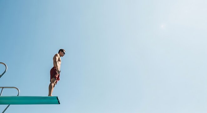 Man Standing on Diving Board Ready to Jump into Clear Blue Sky.
