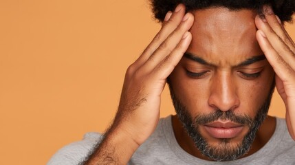 Fototapeta premium Contemplative Man with Head in Hands, Deep in Thought