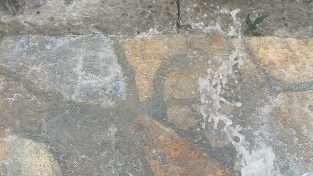 Splashing water on stone surface with texture for use as a natural background or texture