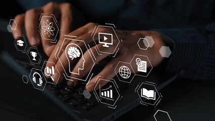 Hands typing on a laptop keyboard with digital icons representing technology, education, data...