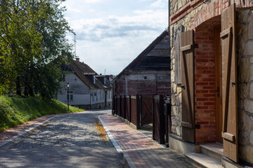 Fototapeta premium Charming cobblestone street in Cesis Latvia under the bright skies of midday, inviting exploration and discovery