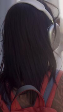 Happy young woman dancing while listening to music outdoors