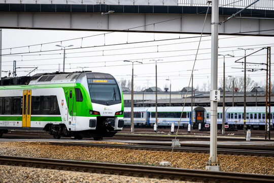 Warsaw, Poland - April 04, 2026: A passenger train traveling on the tracks near the Warszawa Olszynka Grochowska station.