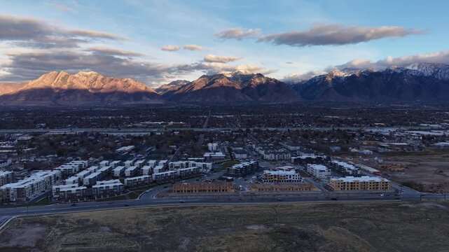 Aerial view of Midvale Utah and sunlit Wasatch Mountains
