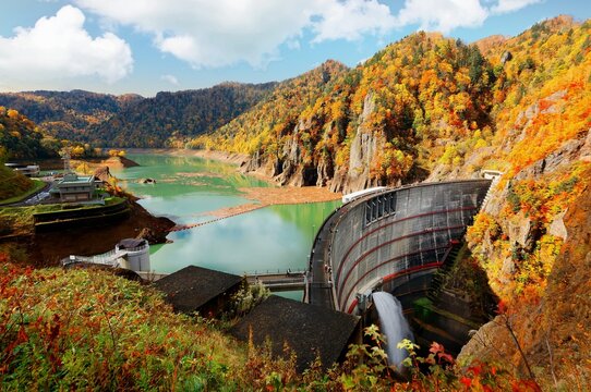 Autumn scenery of vibrant fall colors on the rocky cliffs surrounding Hoheikyo Dam in a beautiful gorge under environmental protection in Shikotsu-Toya National Park, in Sapporo, Hokkaido, Japan