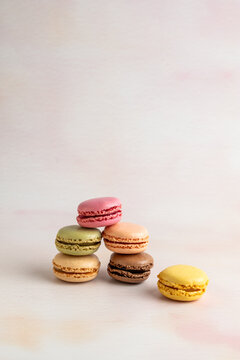 Stack of multi colored macaroons on a light surface 