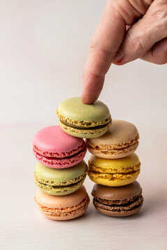 Stack of multi colored macaroons on a light surface 