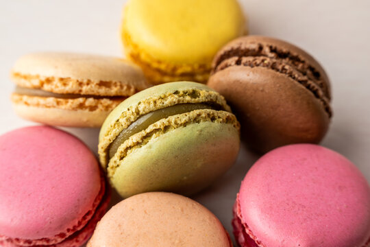 Stack of multi colored macaroons on a light surface 