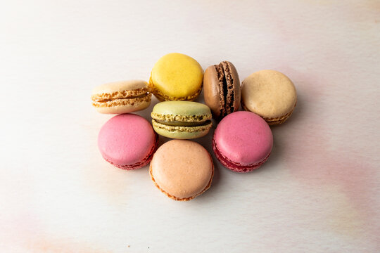 Stack of multi colored macaroons on a light surface 
