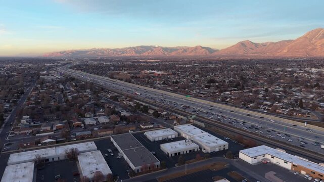 Aerial view of I-15 highway and sunset over Wasatch Mountains in Midvale Utah