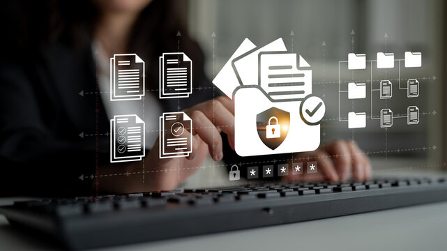 A professional working on document management with a focus on cybersecurity, highlighting secure data handling in a modern office environment. Ledger