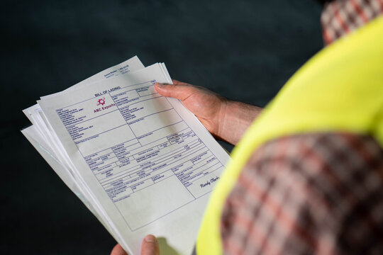 Warehouse worker reviewing documents or bill of lading