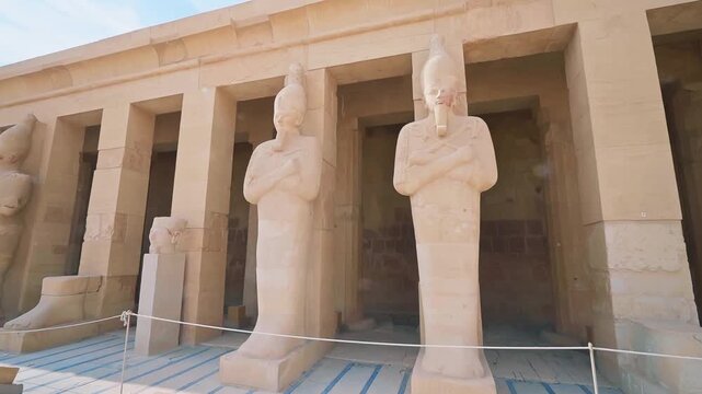 Queen Hatshepsut Temple in Valley of the Kings, Sculptures of Pharaohs at the entrance on floor three of Hatshepsut's Funerary Temple in Luxor, Egypt.Ancient Egyptian wall paintings