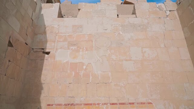 Queen Hatshepsut Temple in Valley of the Kings, Sculptures of Pharaohs at the entrance on floor three of Hatshepsut's Funerary Temple in Luxor, Egypt.Ancient Egyptian wall paintings