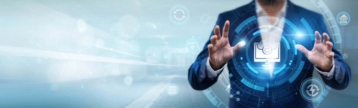 Businessman holding data backup system interface with networking data, cloud storage, information security, disaster recovery and digital protection concept