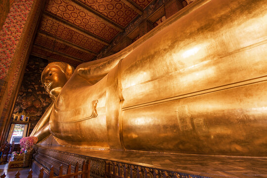 The magnificent Golden Reclining Buddha statue at Wat Pho Temple, Bangkok, Thailand.