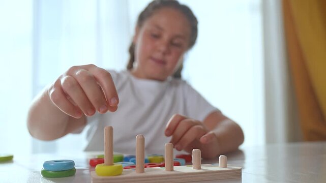 Kid having fun with jigsaw puzzle. Young girl playing with colorful jigsaw pieces. Developing fine motor skills while solving puzzle. Child focused on assembling jigsaw. Fun activity for kid indoors.