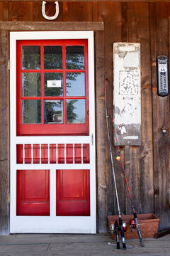 Rustic red door on weathered wooden exterior