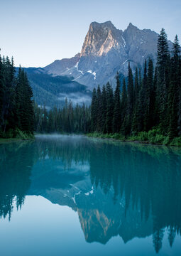 Mountain and forest reflections in Emerald Lake at sunrise, Yoho National Park, Shuswap Regional District, British Columbia, Canada