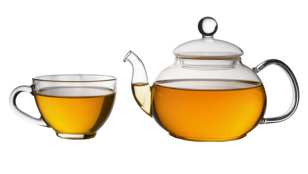 Isolated elegant glass teapot and matching teacup filled with delicious hot amber tea