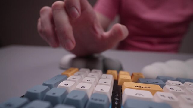 Freelancer typing on ergonomic keyboard with wrist rest for carpal tunnel syndrome prevention, concept of proper hand posture and comfortable computing experience, close-up. Shooting in slow motion.