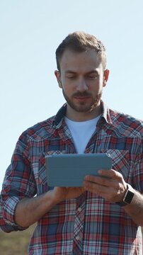 A person sitting comfortably and using a tablet in a scenic outdoor landscape setting