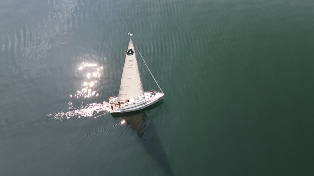 Aerial view of white sailing yacht on Lake Constance with sparkling water, Germany