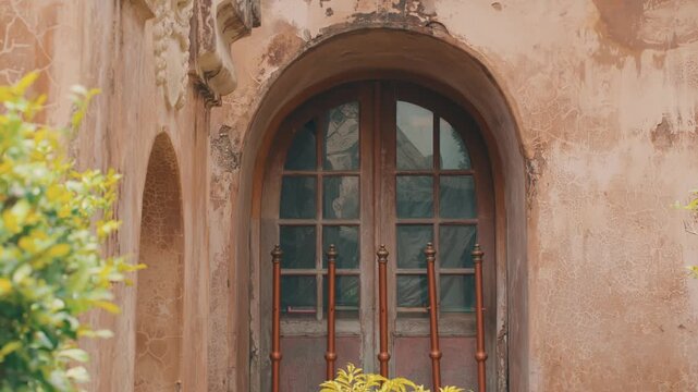 A weathered, rustic wooden double door set within an arched stone frame of an old heritage building, capturing a sense of time, history, and architectural charm in soft light.