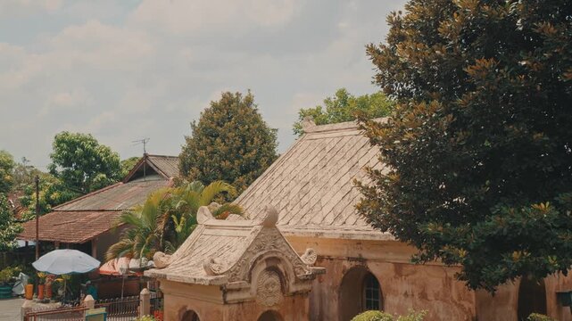Close-up of the traditional tiered roof and ornate stone carvings of the historic Kotagede Mosque in Yogyakarta, showcasing preserved Indonesian cultural heritage.