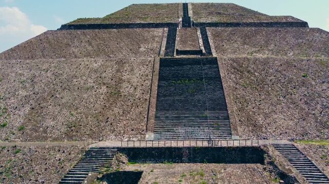 Close aerial drone view of Pyramid of the Sun stairway and stone facade at Teotihuacan, Mexico