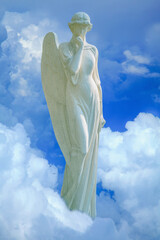 Fototapeta premium Heavenly angel standing above clouds, symbolizing peace, hope and spiritual guidance in a bright sky with soft light and serene atmosphere