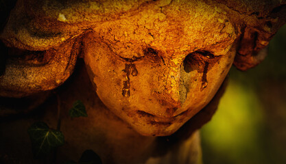 Fototapeta premium Stone angel crying, symbolizing grief, vulnerability, and the idea that even protectors experience pain.