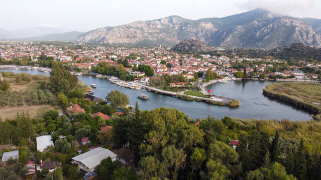 Aerial High Angle View of Dalyan River Canal and Town with Mountains and Boats in Mugla Turkey
