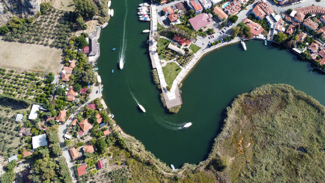Aerial High Angle View of Dalyan River Canal and Town with Mountains and Boats in Mugla Turkey
