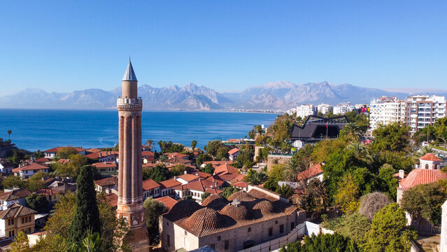 Aerial High Angle View of Historic Yivli Minaret Mosque and Kaleici Old Town with Taurus Mountains in Antalya Turkey